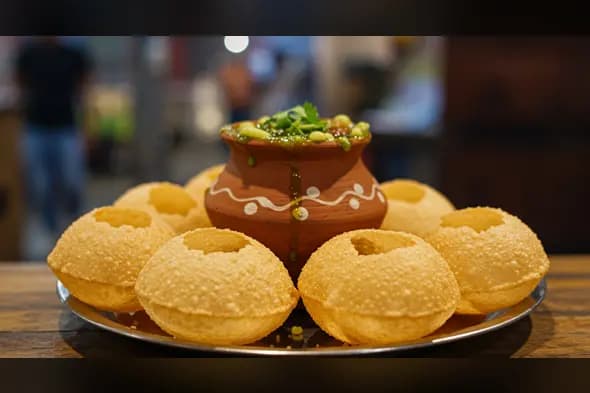 Garnished Indian Pani Puri Thali with Green Masala Water in Clay Pot | AIClips