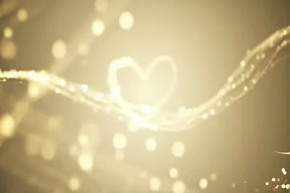Golden Abstract Heart Shape with Sparkling Light Particles Background