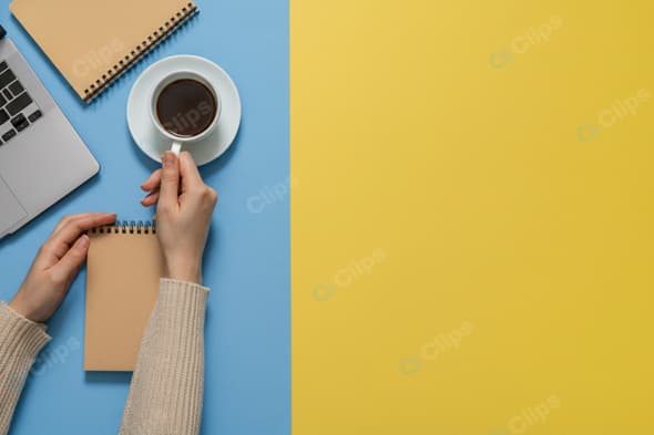 Workspace with Laptop, Coffee, and Notepads on Colorful Background