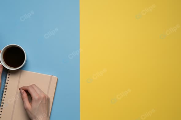 Coffee and Notebook on Colorful Desk Workspace