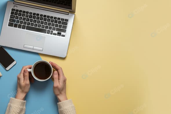 Laptop Workspace with Coffee and Smartphone on Colorful Background