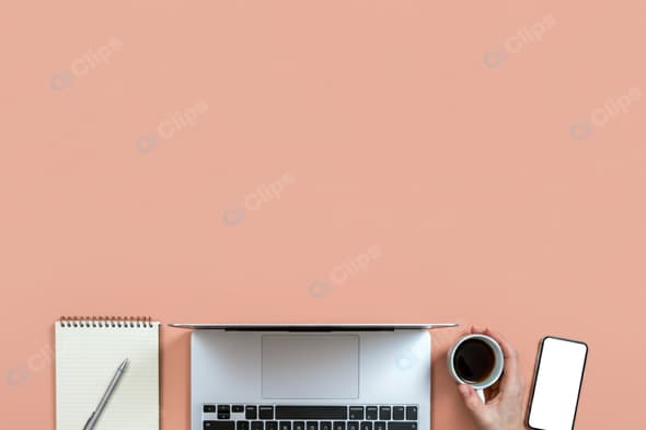Laptop Workspace with Coffee, Smartphone, and Notepad on Peach Background