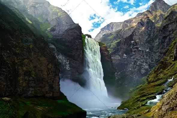 Majestic Mountain Waterfall Cascading Through Rocky Canyon