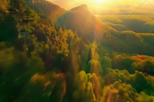 Golden Sunlight Over Mountain Range with Dramatic Lens Flare