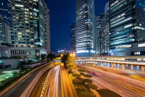 Modern City Highway with Light Trails and Illuminated Skyscrapers