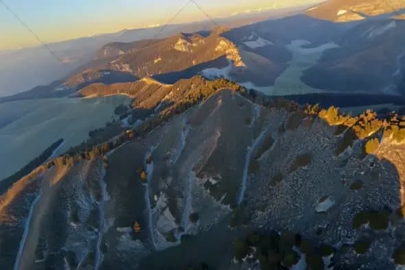 Sunset Mountain Range Aerial View with Golden Light on Peaks