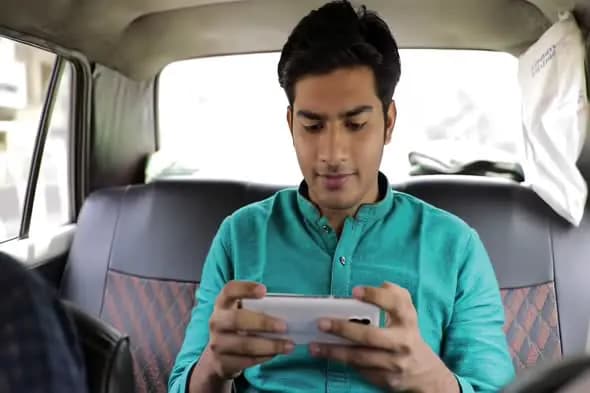 Passenger Using Smartphone in Taxi