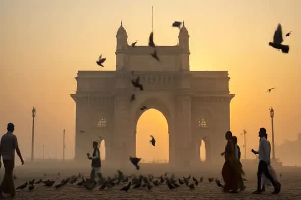 Sunrise at Gateway of India Mumbai with Flying Pigeons and Walking People