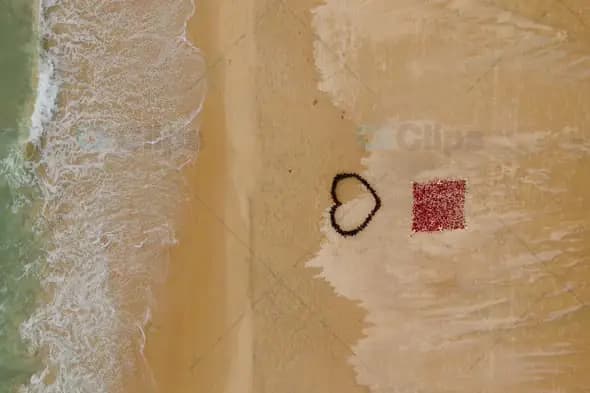Heart and Red Pattern on Sandy Beach with Waves
