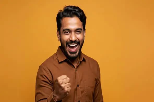 Confident Indian Man Celebrating with Joyful Expression on Yellow Background