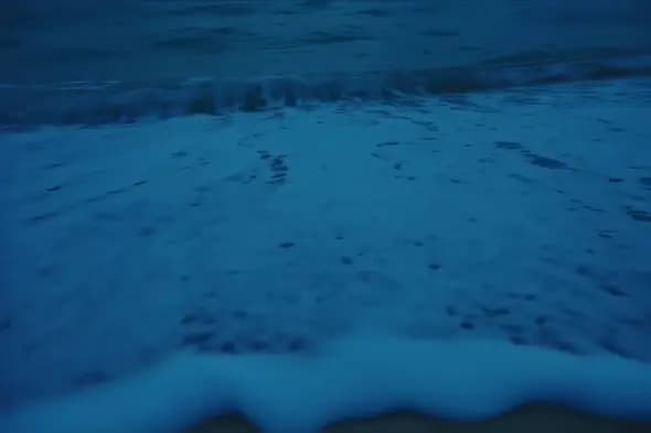 Mesmerizing Blue Ocean Waves Rolling Onto Sandy Shore