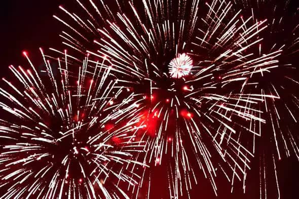Red and White Fireworks Explosion in Night Sky